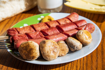 Hot dogs with mushrooms on a white plate...,