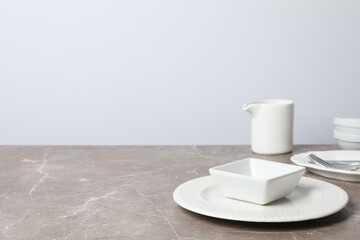 Minimal table setting with blank dish, space for text