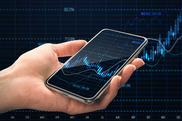 Close up of female hand holding mobile phone with glowing candlestick forex chart and index on dark grid background. Trade, stock and finance concept. Double exposure.