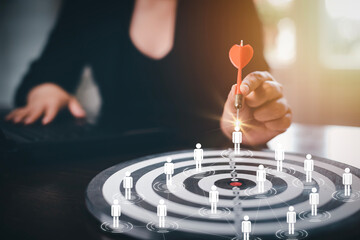 Targeting with Human team icon business concept, Businesswoman hand holding red dart to the virtual...
