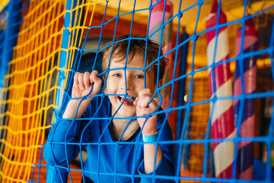 Little happy boy on the playground, children's play center.