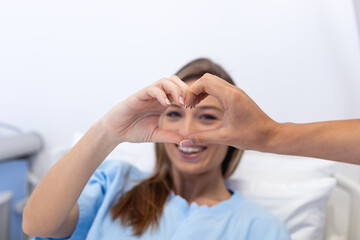 Doctor and patient make finger heart shape , professional medical safety and hygiene protection from Coronavirus disease COVID-19 and surgery