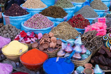 Colorful soaps, spices and perfumes for sale in a market in a souk in the Medina around the Jemaa...