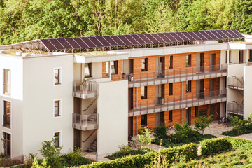 Modern Eco Friendly Residential House with Solar Roof, Wooden Facade and Garden. Solar Panels on...