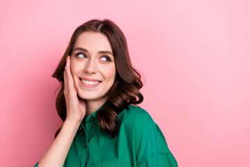 Fototapeta premium Photo of positive charming lady dressed green blouse arm cheek looking empty space isolated pink color background
