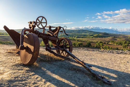 Italy, Tuscany, San Quirico d'Orcia, Rusty plow in Val d'Orcia