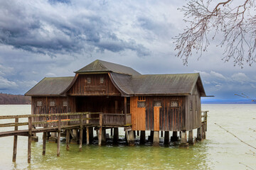 Boathouse in Stegen am Ammersee on a cold windy day with cloudy sky