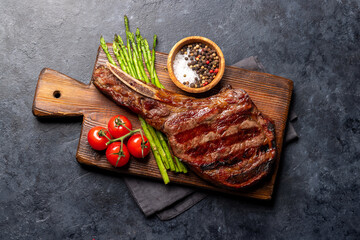 Medium rare grilled Tomahawk beef steak with asparagus