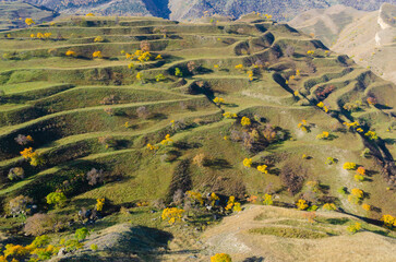 Mountain landscape with green agricultural terraces on the slopes in the Caucasus mountains.