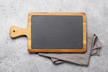 Obraz na płótnie Canvas Wooden cutting board and kitchen towel