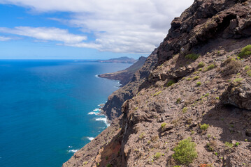 Fototapeta premium View of volcanic cliffs and Atlantic ocean from the lookout terrace Mirador del Balcon on the island of Gran Canaria, Spain. 