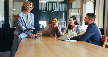 Group of tech professionals having a meeting in a boardroom