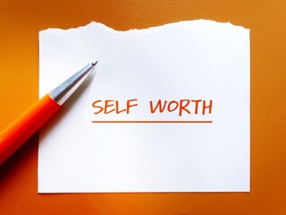 Torn paper on orange background with handwritten text SELF WORTH, refers to self-love, being...