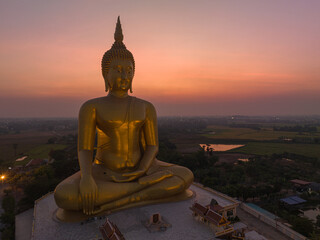 Obraz premium aerial view beautiful sky in twilight at the Biggest Buddha in the world at wat Maung Angtong Thailand. scenery sky in twilight background.the one famous landmarks in Thailand.