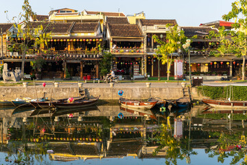Hoi An quiet street by the river at sunrise when local people start their day