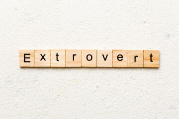 extrovert word written on wood block. extrovert text on table, concept