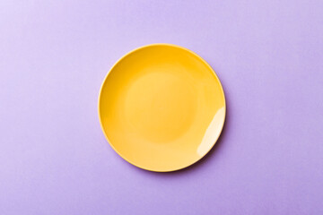 Top view of isolated of colored background empty round yellow plate for food. Empty dish with space for your design