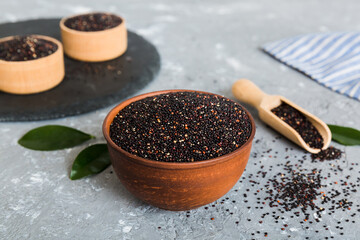 quinoa seeds in bowl and spoon on colored background. Healthy kinwa in small bowl. Healthy superfood
