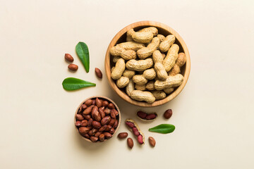 Fresh healthy peanuts in bowl on colored table background. Top view Healthy eating bertholletia concept. Super foods