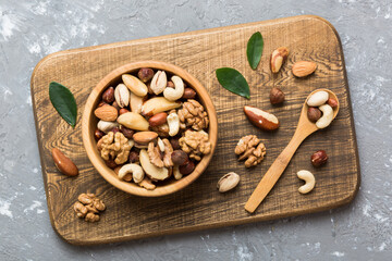 mixed nuts in bowl. Mix of various nuts on colored background. pistachios, cashews, walnuts, hazelnuts, peanuts and brazil nuts
