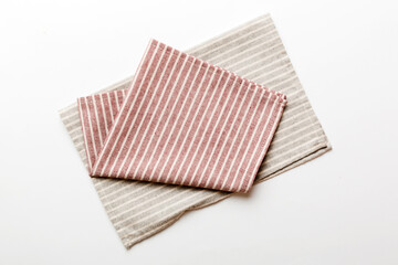 top view with red empty kitchen napkin isolated on table background. Folded cloth for mockup with copy space, Flat lay. Minimal style