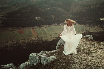 Lone woman on a desolate mountain top