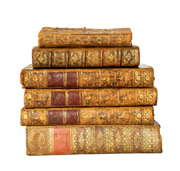 Pile of antique books with a leather cover and golden ornaments on white