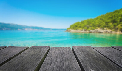 Empty wooden table with blurred beach background