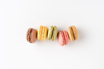 Sweet macaroons on white background with copyspace. Flat lay