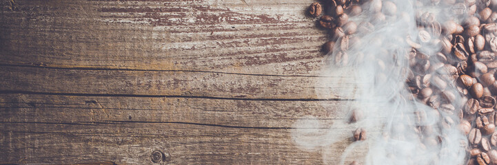 Overhead shot of coffee beans on an old wooden table