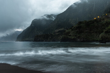 Famous volcanic black sand beach in Seixal, Madeira at dramatic cloudy weather