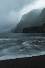 Famous volcanic black sand beach in Seixal, Madeira at dramatic cloudy weather