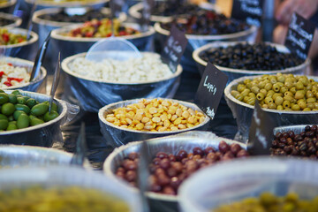 Olives and marinated garlic on farmer market in Cucuron, Provence, France