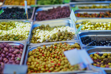Olives and marinated garlic on farmer market in Cucuron, Provence, France