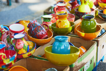 Fototapeta na wymiar Colorful clay crockery on farmer market in Cucuron, Provence, France