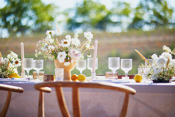 Beautiful table set with candles and flowers for a festive event, party or wedding reception