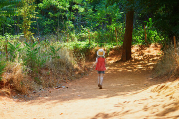 Cheerful preschooler girl at famous Ochre path through large ochre deposits in Roussillon, Provence, France