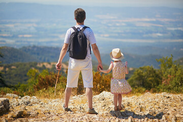 Father and daughter enjoying beautiful view from the top of the hill in Provence, Southern France - obrazy, fototapety, plakaty