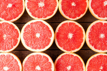 Overhead shot of juicy grapefruits on wooden table