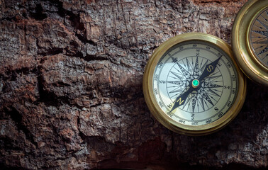 Fototapeta na wymiar Golden compass on wood background concept for direction, navigation and travel