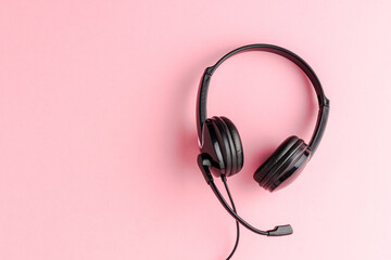 Overheadshot of headset on background with copyspace. Call center concept