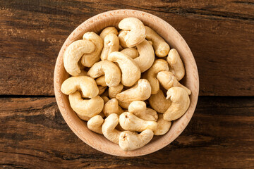 Fresh cashews in bowl on wooden table. Healthy snacks