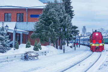 Passenger train stands by the platform before departure.