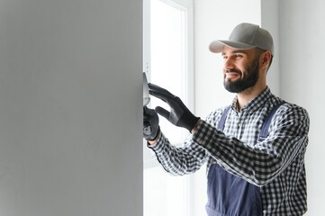 Young worker making repair in room