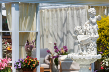 Sculpture of angel and fountain in backyard flower garden