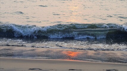 Waves on the beach of sea on sunset
