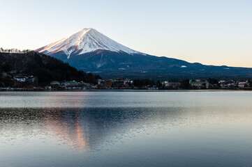 Mount Fuji on a bright winter morning, as seen from across lake Kawaguchi, and the nearby town of Kawaguchiko.