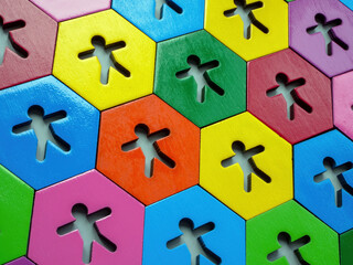 Multi-colored figures on hexagonal plates. Allyship concept.