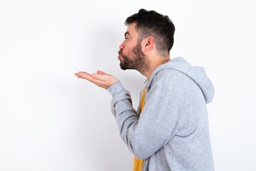 Profile side view, portrait of attractive Young caucasian mán wearing trendy clothes over white...