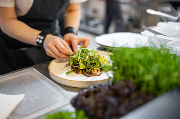 Chef cooking vegetables salad on restaurant kitchen